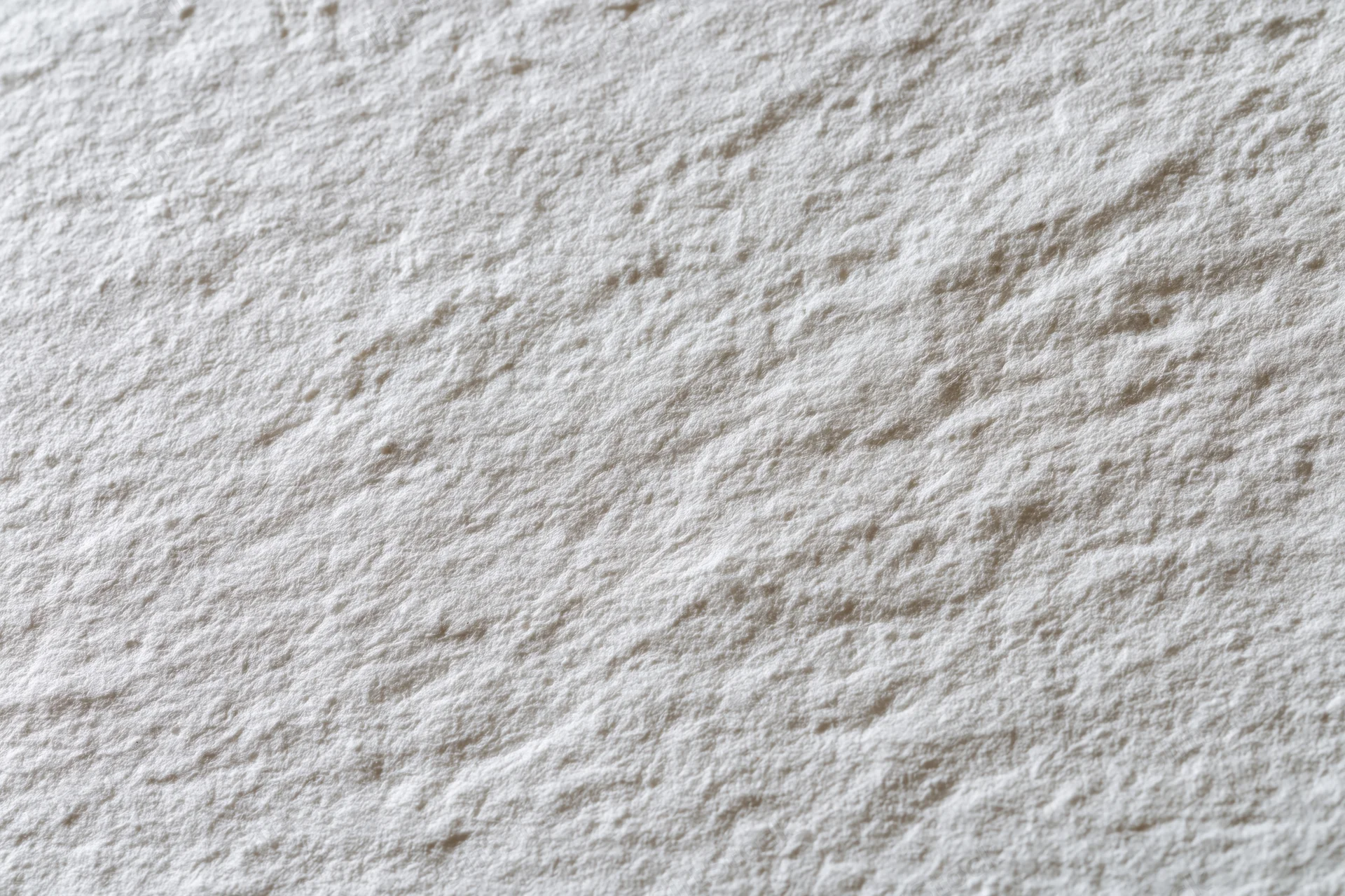 Close-up flat lay of white textured paper surface filling the frame