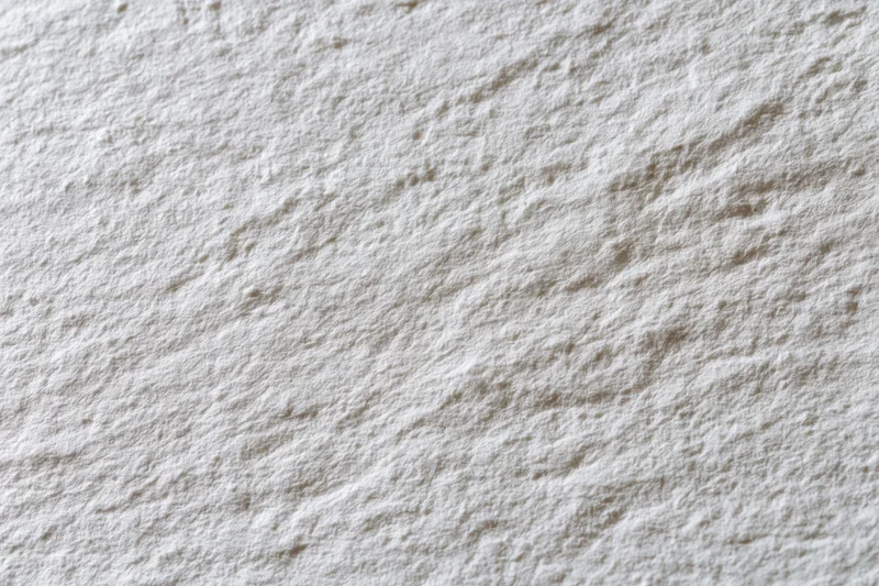 Close-up flat lay of white textured paper surface filling the frame