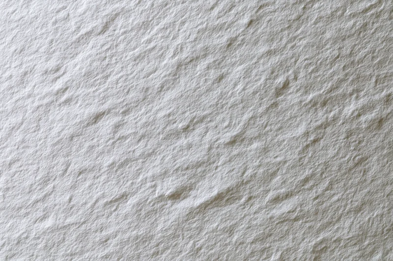 Close-up of white textured paper surface filling the frame