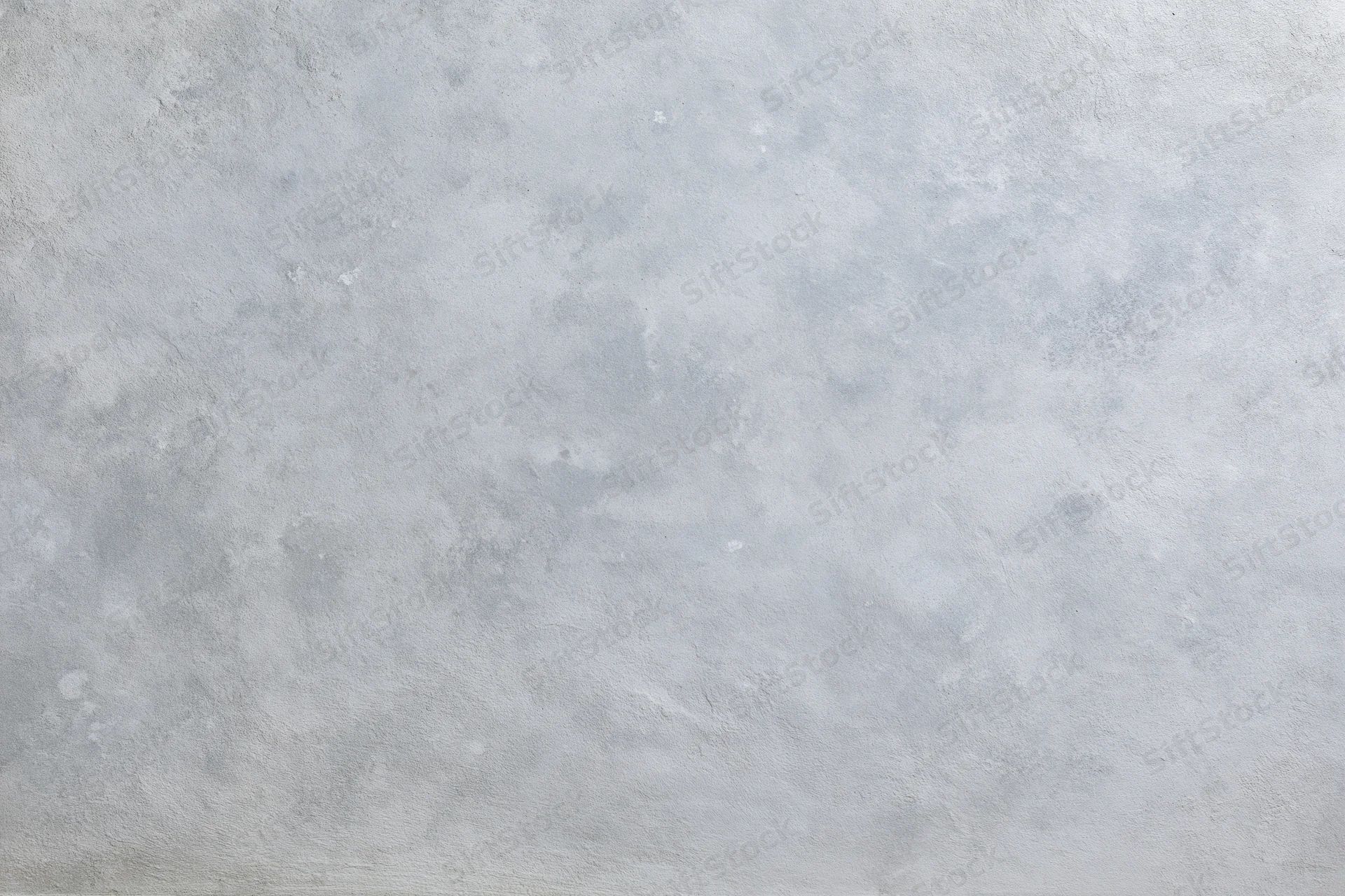 Close-up of a bare concrete wall surface filling the frame with rough texture and gray tone