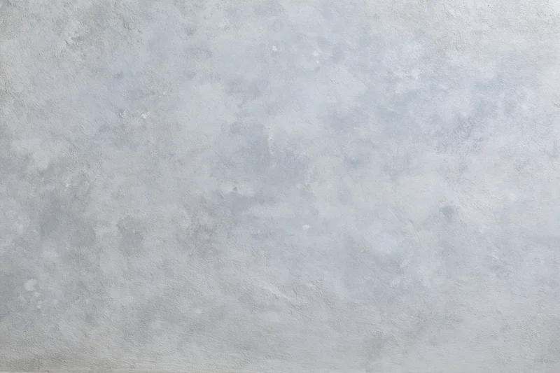 Close-up of a bare concrete wall surface filling the frame with rough texture and gray tone