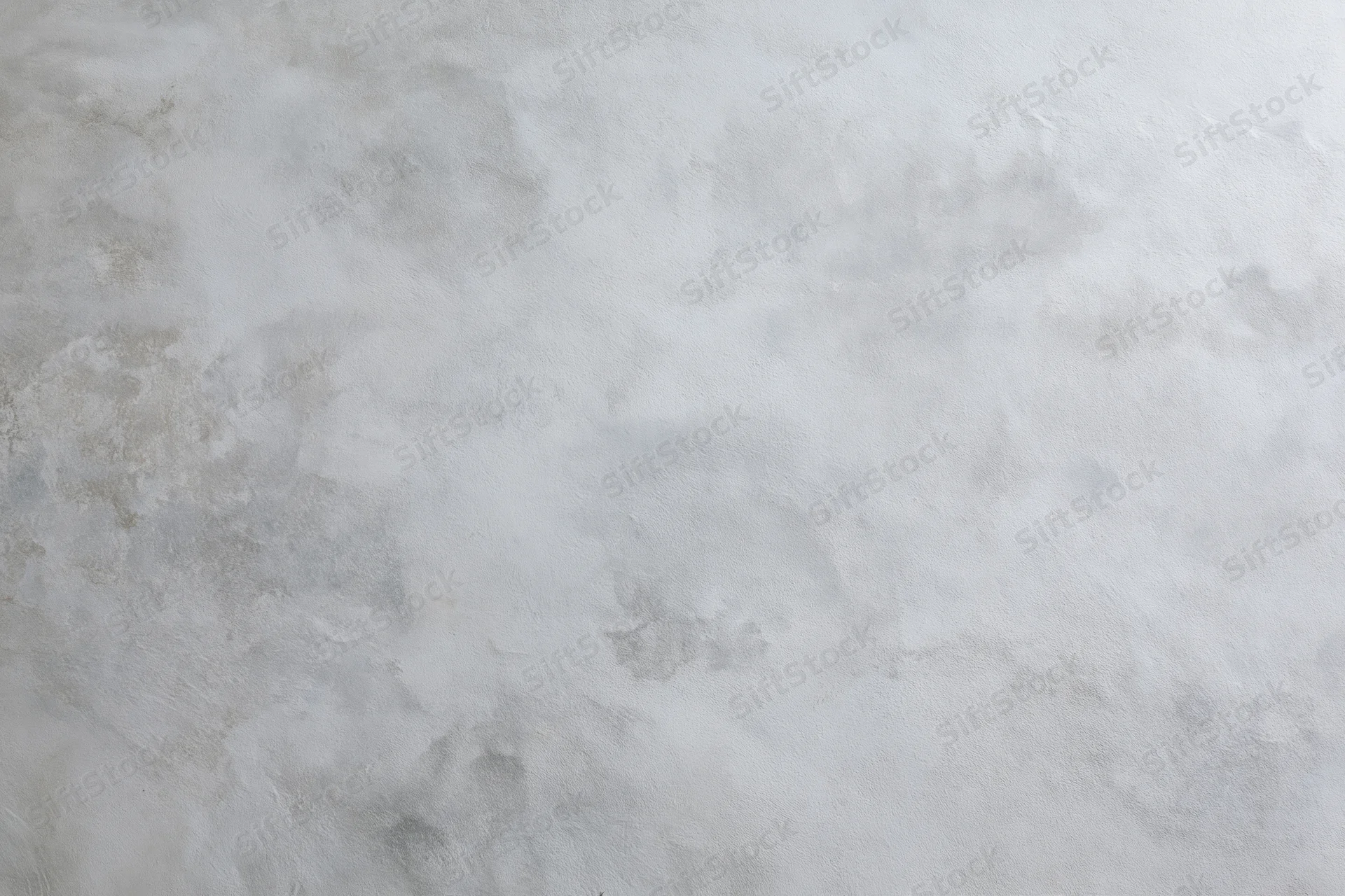Close-up of a bare concrete wall surface filling the frame with rough texture and gray tones