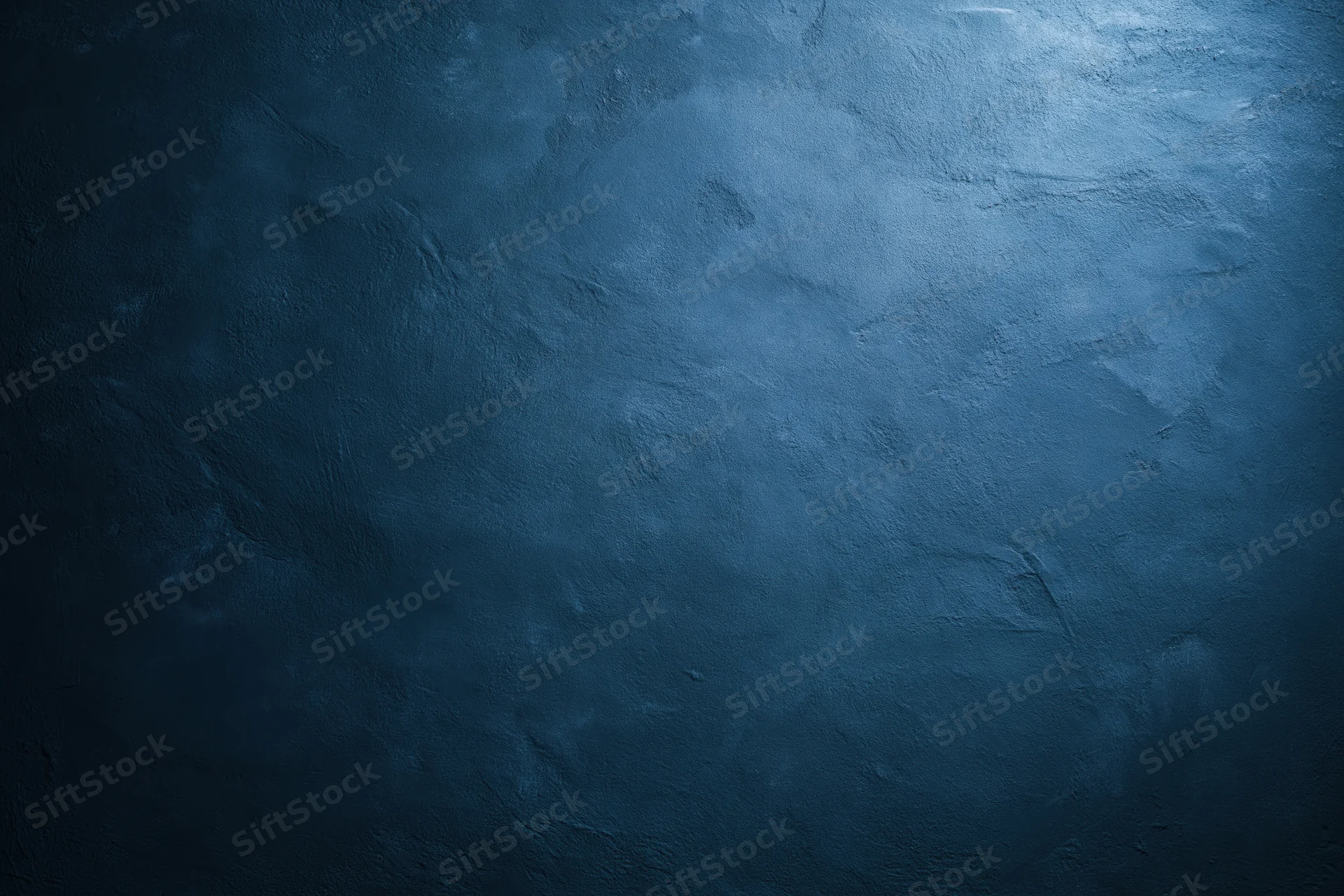 Close-up of a plain painted concrete wall with matte texture and blue-gray tone
