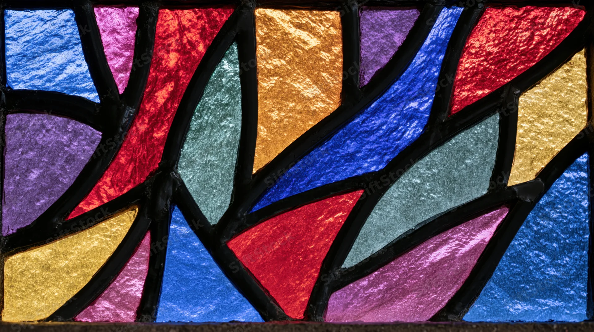 Close-up of colorful gothic arch stained glass window in a church interior