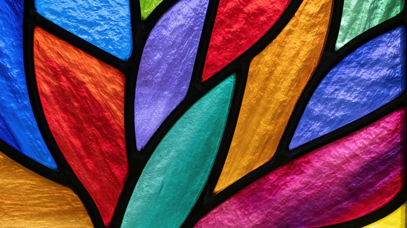 Close-up of colorful gothic arch stained glass window with leaded panels in church interior