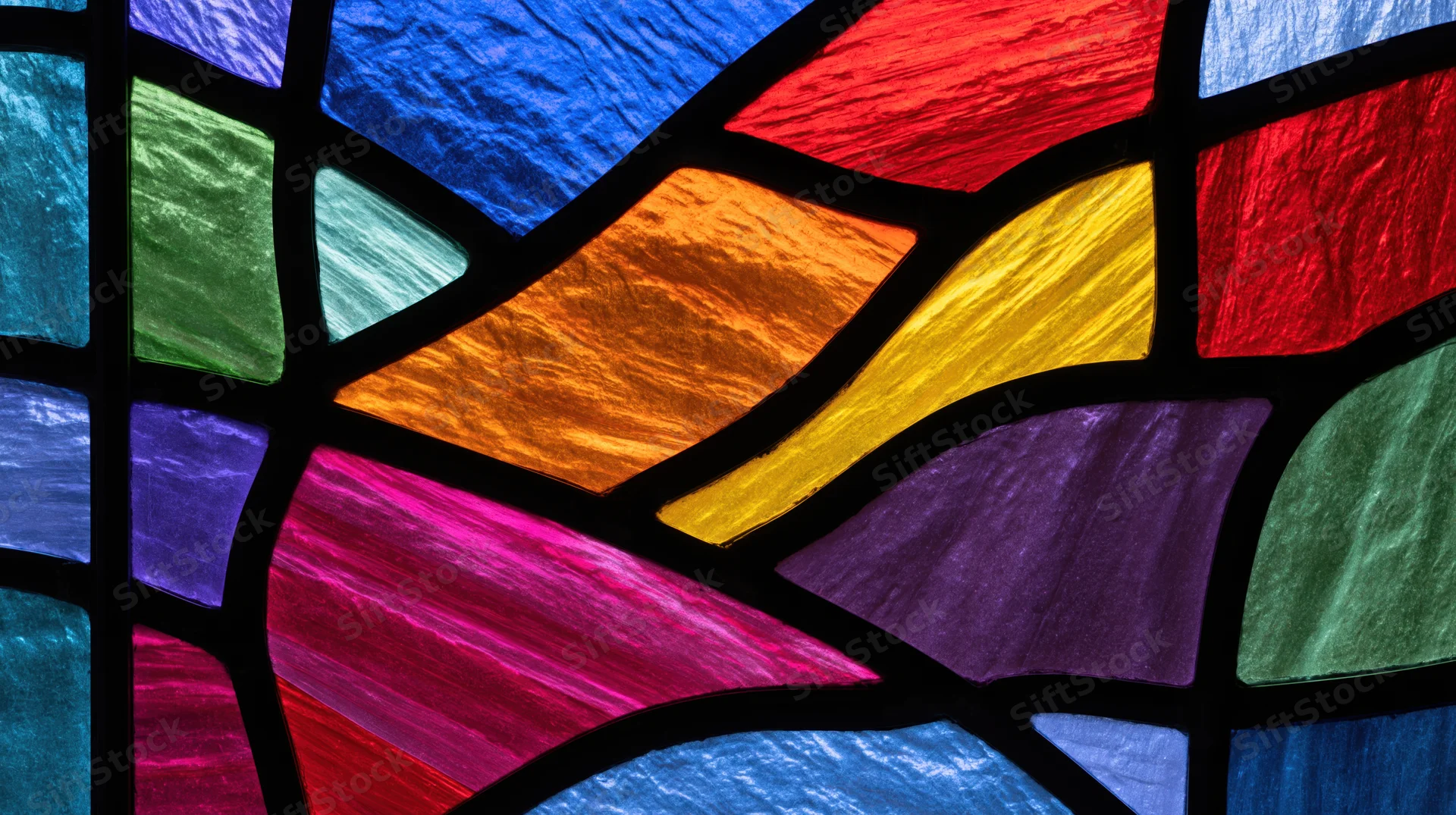 Close-up of colorful stained glass window with gothic arches and leaded glass panels in a church interior