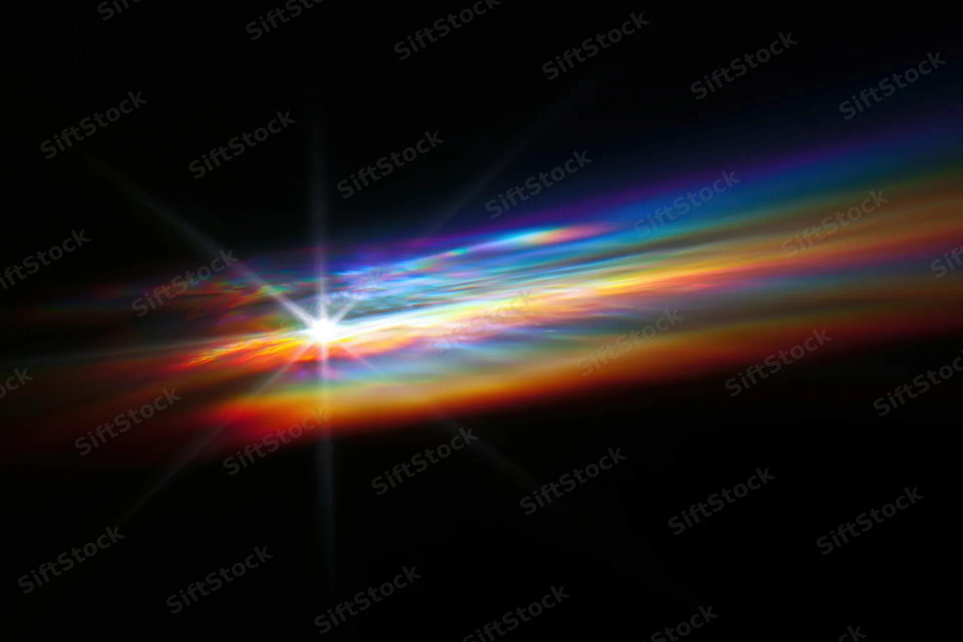 Rainbow light diffraction pattern floating against dark background with starburst glow and color spectrum trails