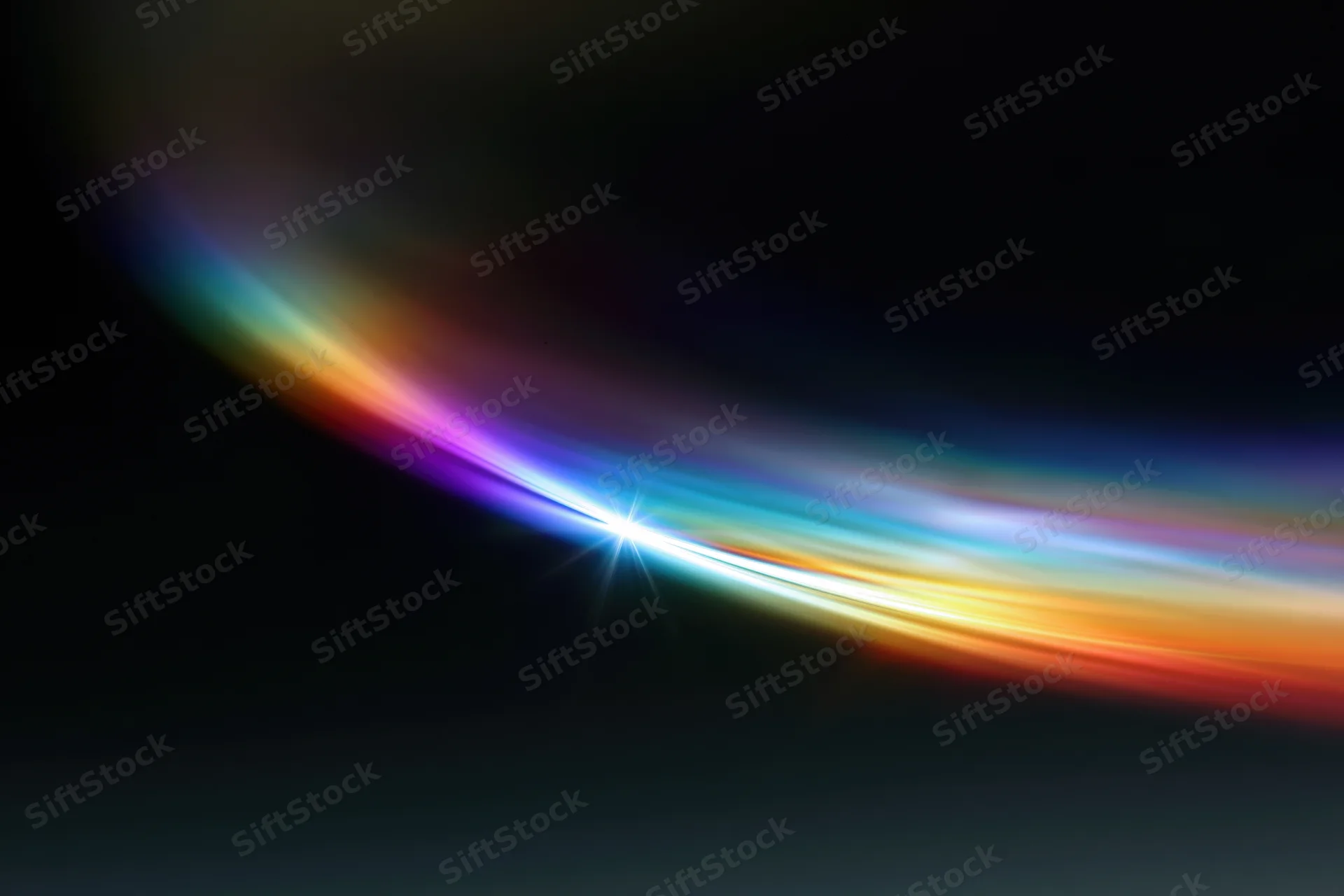 Rainbow light diffraction pattern floating against dark background with bright central flare and colorful arc
