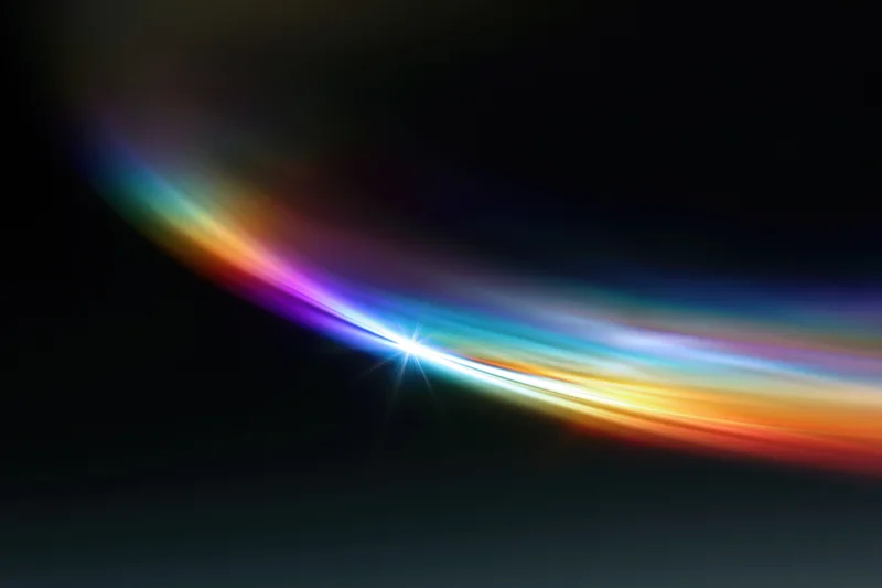Rainbow light diffraction pattern floating against dark background with bright central flare and colorful arc