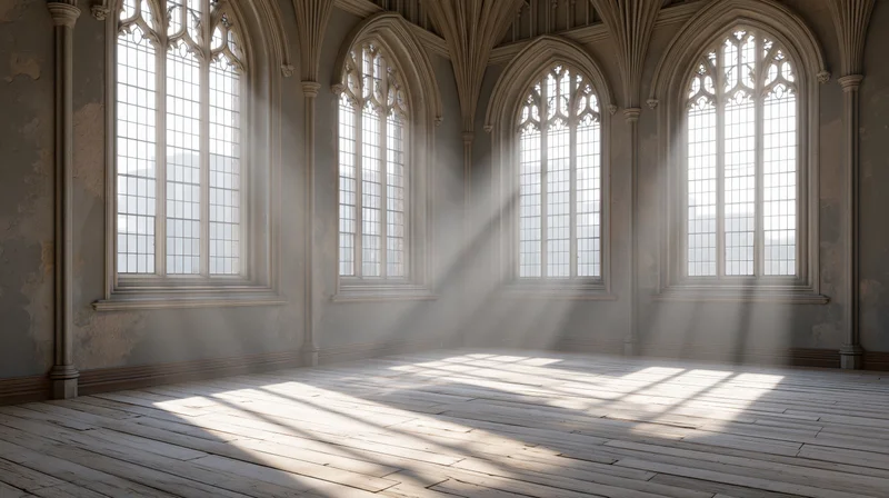 Empty gothic chapel interior with sunlight streaming through tall arched windows onto wooden floor