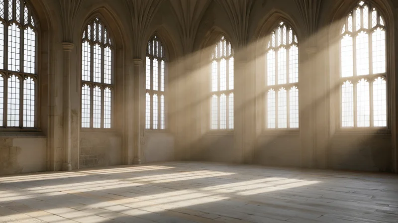Empty gothic chapel interior with sunlight streaming through tall arched windows onto wooden floor