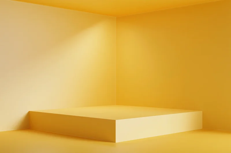 Minimalist yellow pedestal in a corner studio space