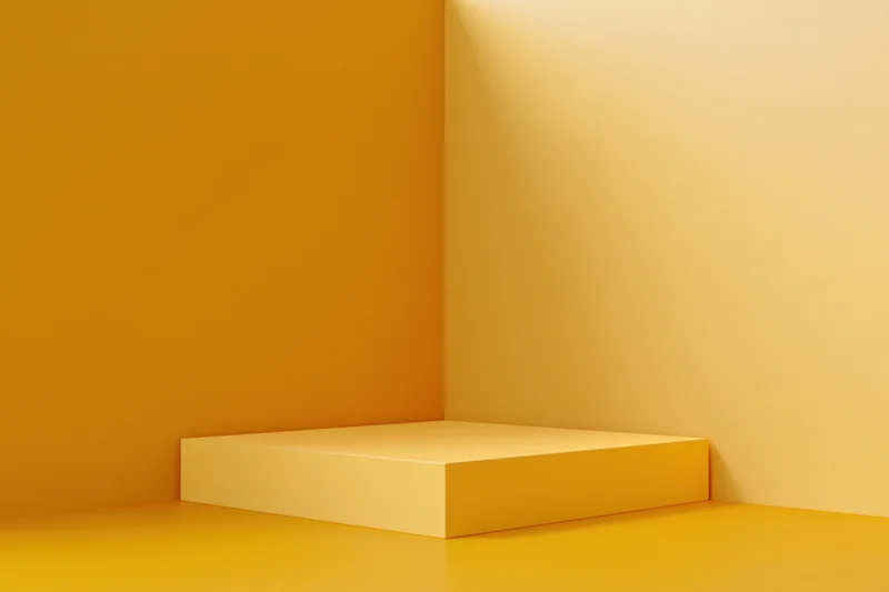 Minimalist yellow product display pedestal in a studio corner