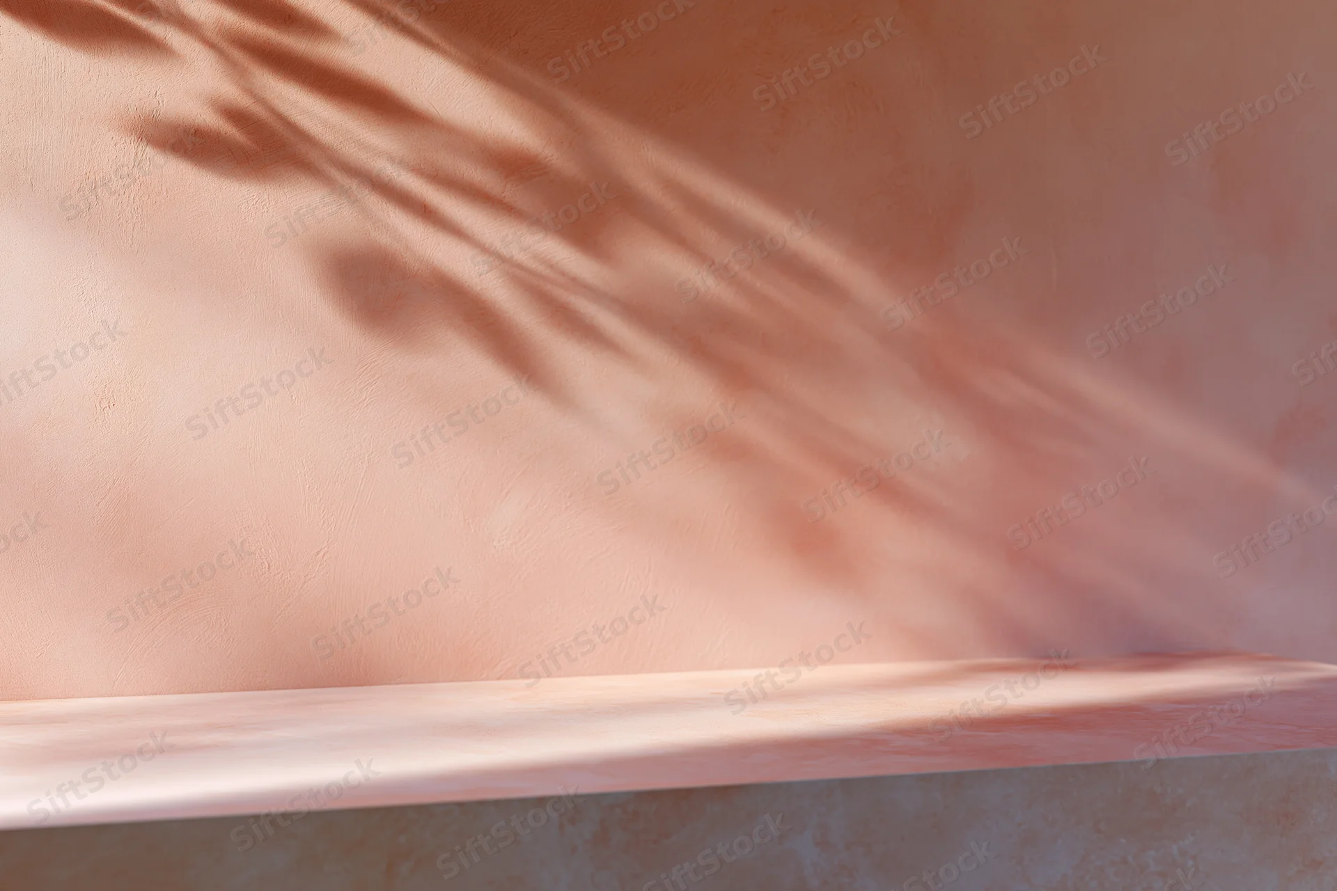 Empty flat tabletop surface against textured peach wall with dappled leaf shadows
