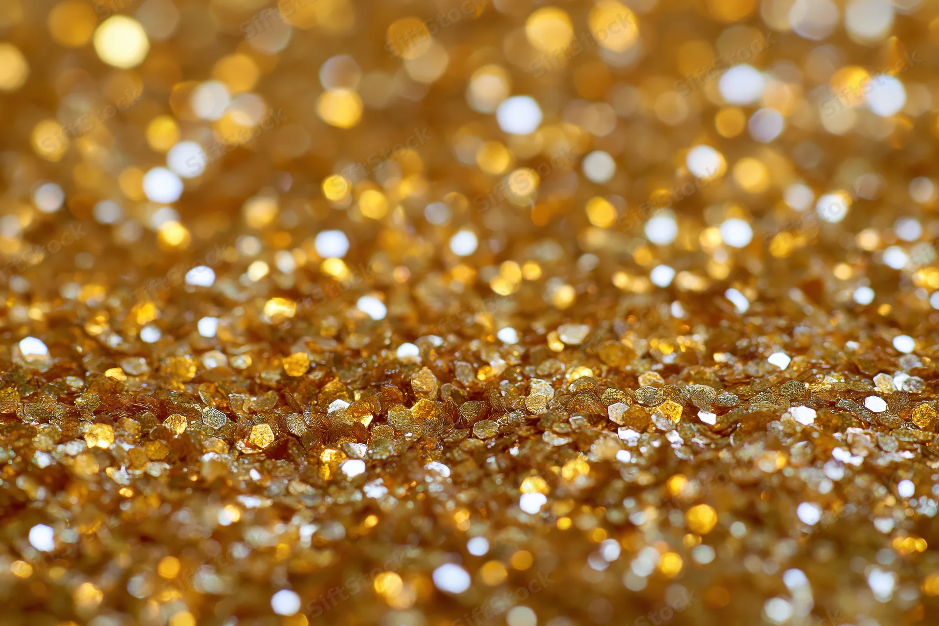 Gold glitter texture in extreme closeup with sparkling bokeh effect