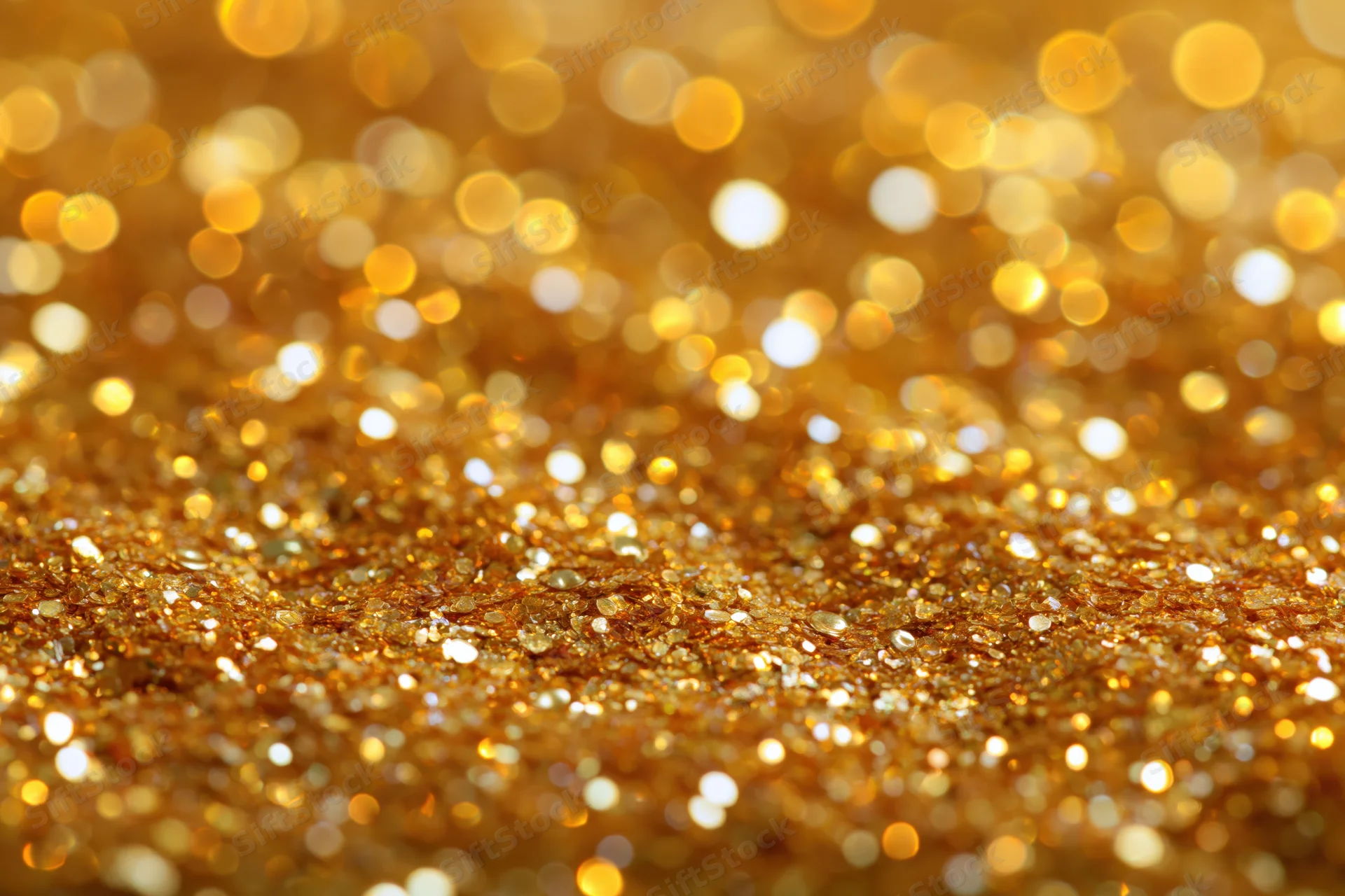 Gold glitter texture with sparkling bokeh effect filling the frame