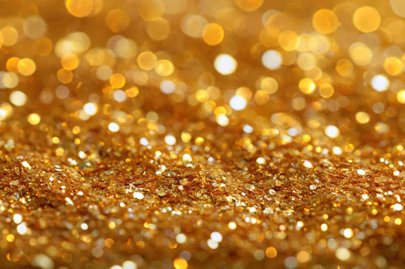 Gold glitter texture with sparkling bokeh effect filling the frame