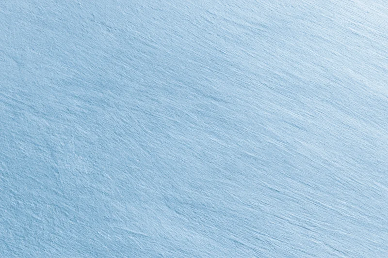 Light blue brushed surface filling the frame as a seamless background