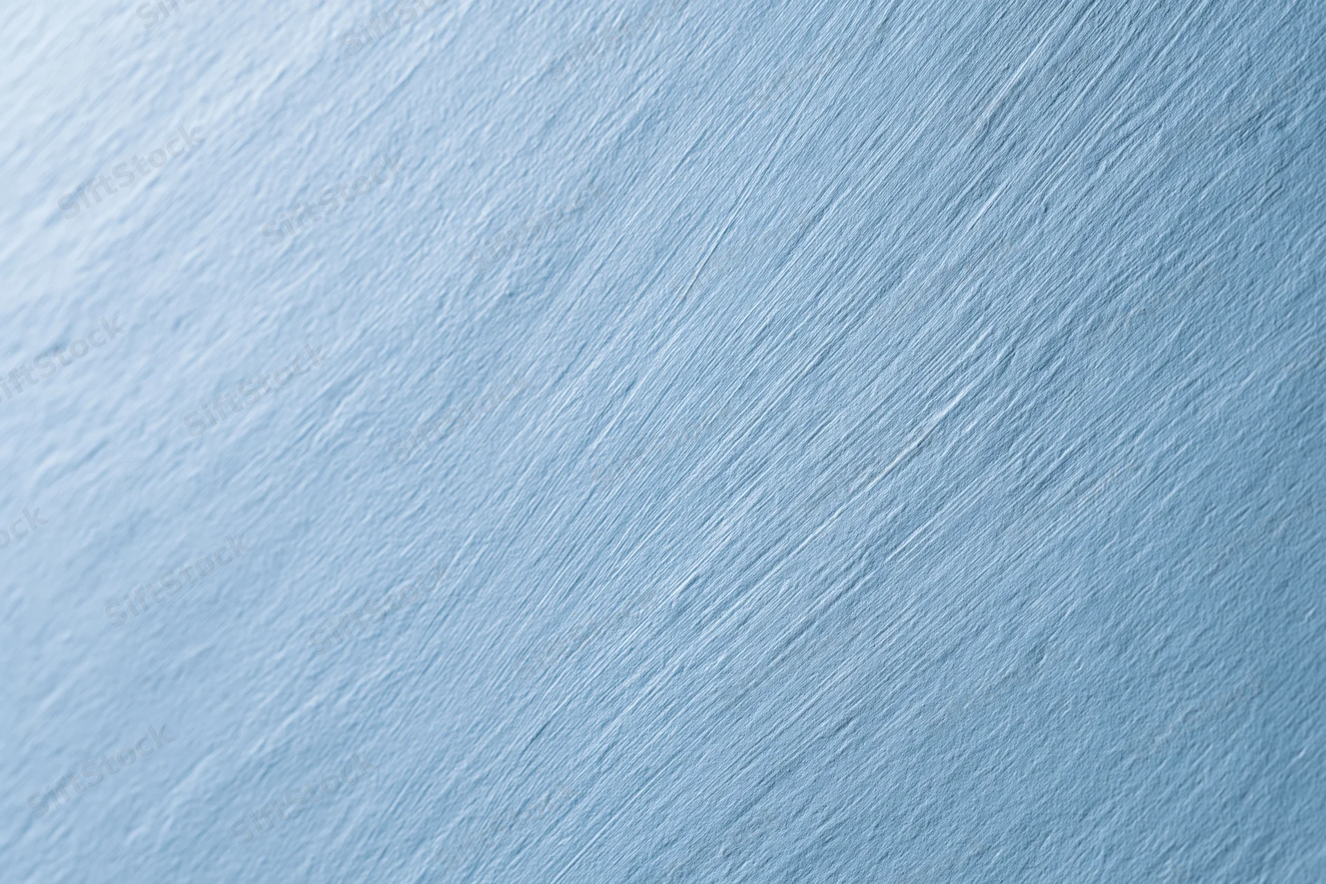 Flat brushed light blue surface filling the frame as a seamless background