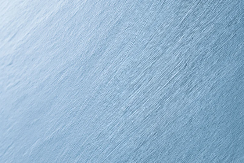Flat brushed light blue surface filling the frame as a seamless background