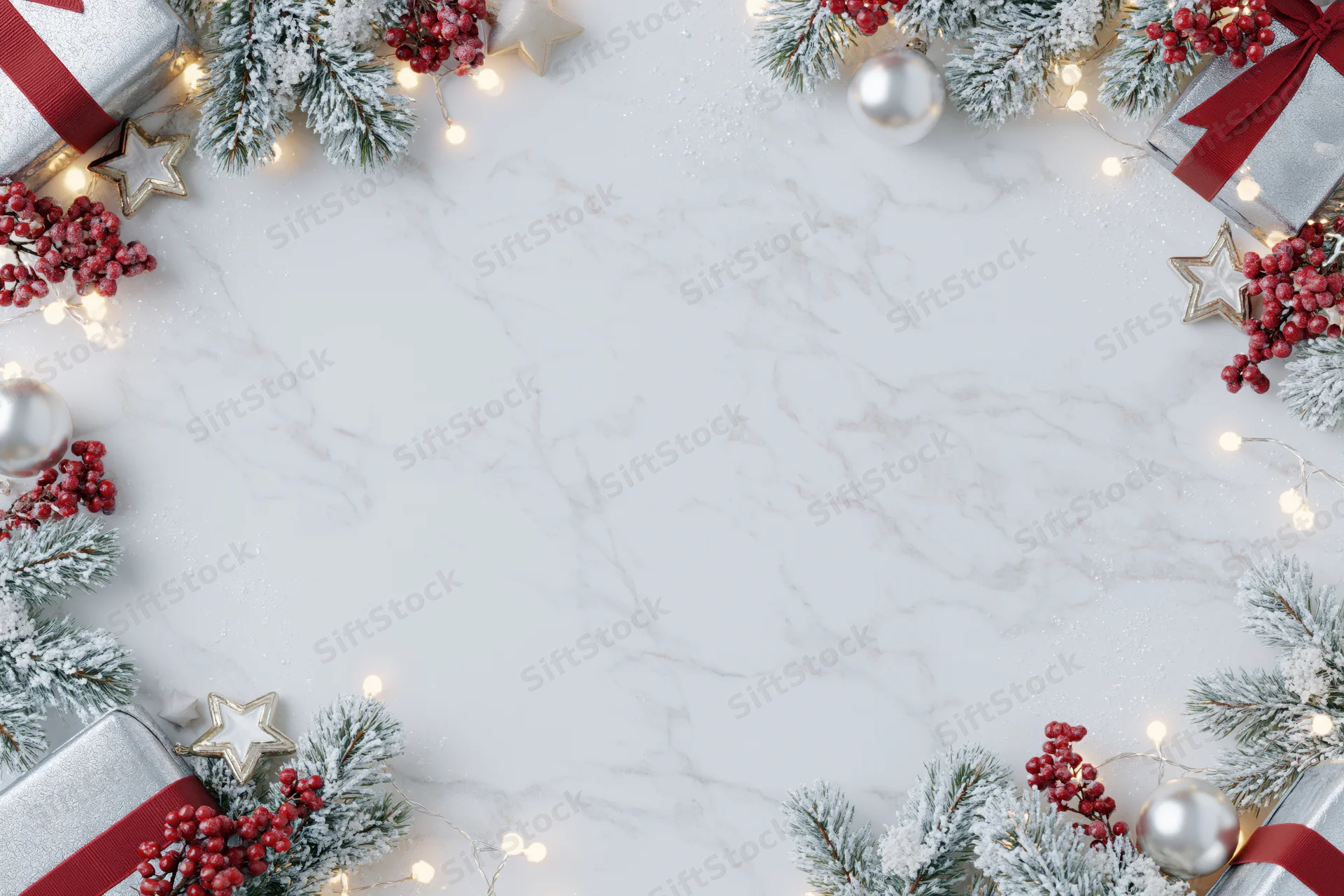 Christmas border frame with pine, berries, gifts and lights on white marble surface
