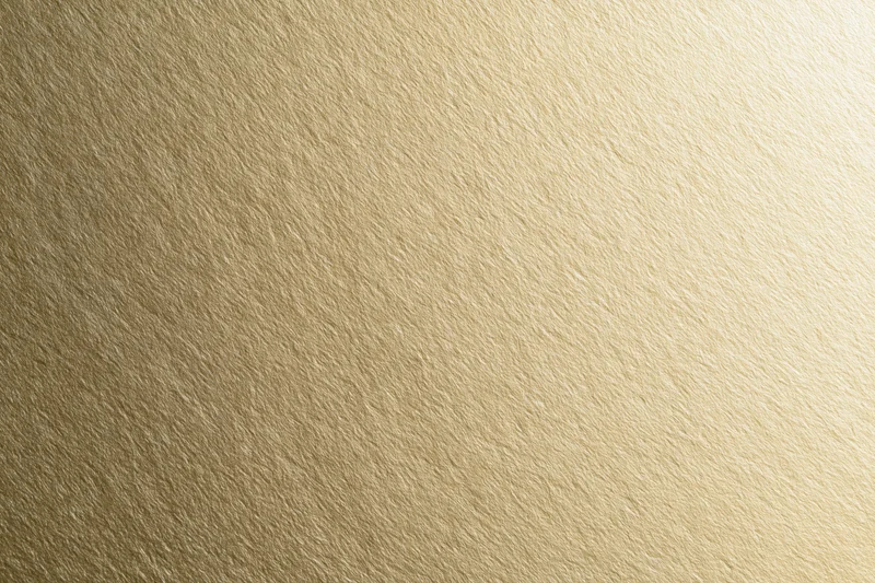 Flat matte gold metallic surface filling the frame as a seamless background