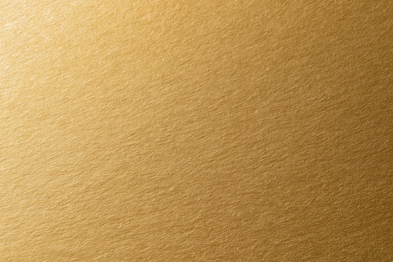 Flat matte gold metallic surface filling the frame as a seamless background