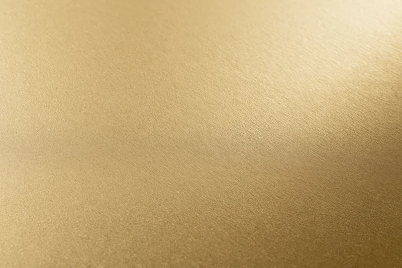 Flat matte gold metallic surface filling the frame as a seamless background