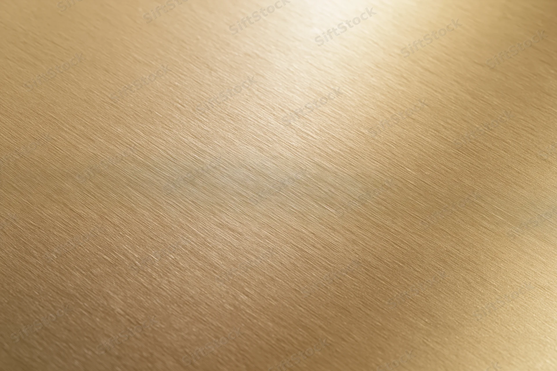 Flat matte gold metallic surface filling the frame with brushed texture and warm gradient lighting