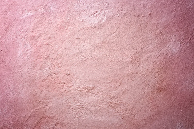Matte pink textured surface filling the frame as a background