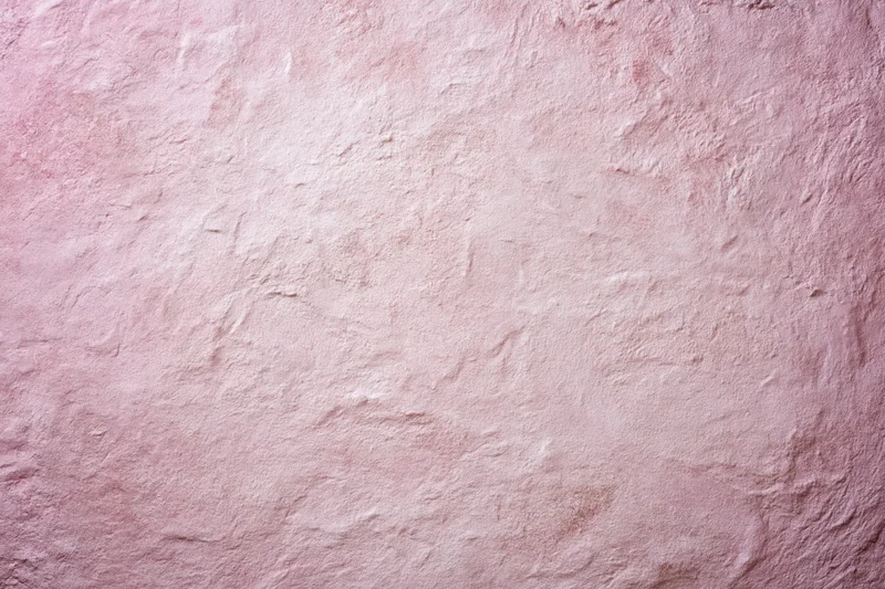 Matte pink textured surface filling the frame as a background