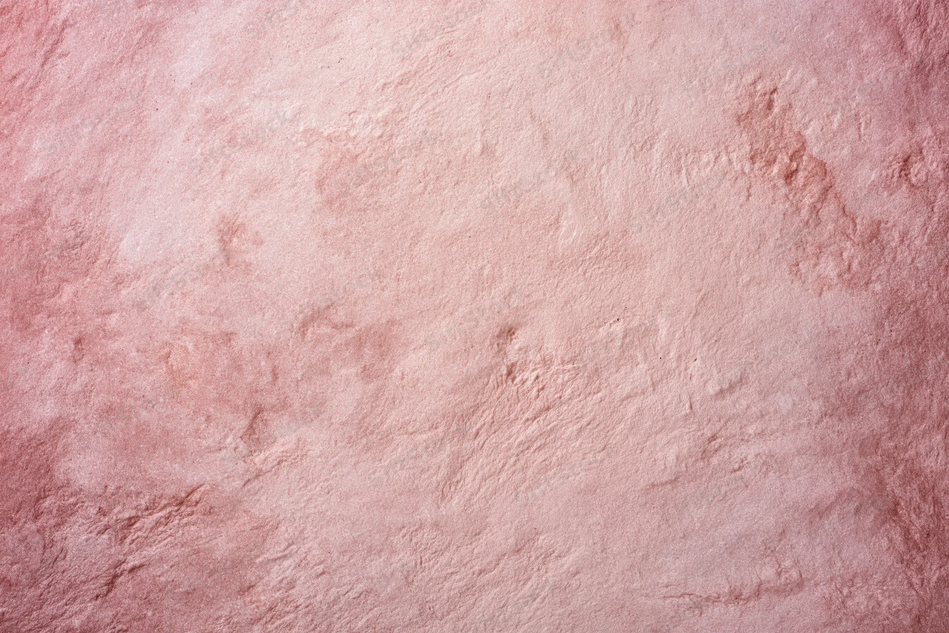 Matte pink textured surface filling the frame as a background