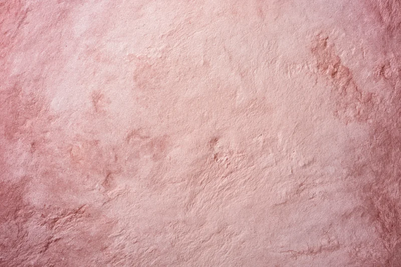 Matte pink textured surface filling the frame as a background