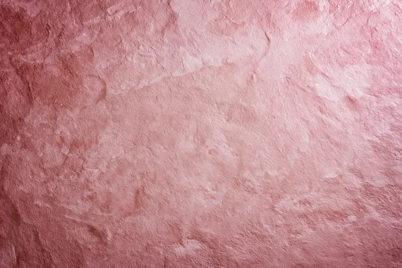 Matte pink textured surface filling the frame as a background