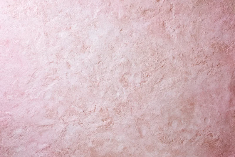 Matte pink textured surface filling the frame as a background