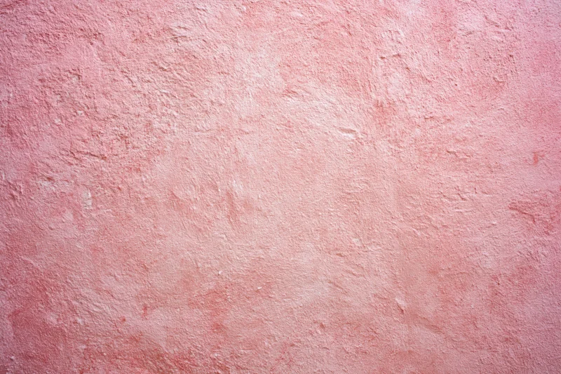 Matte pink textured surface filling the frame as a background