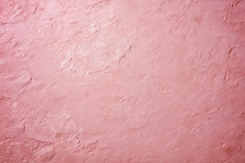 Matte pink textured surface filling the frame as a background