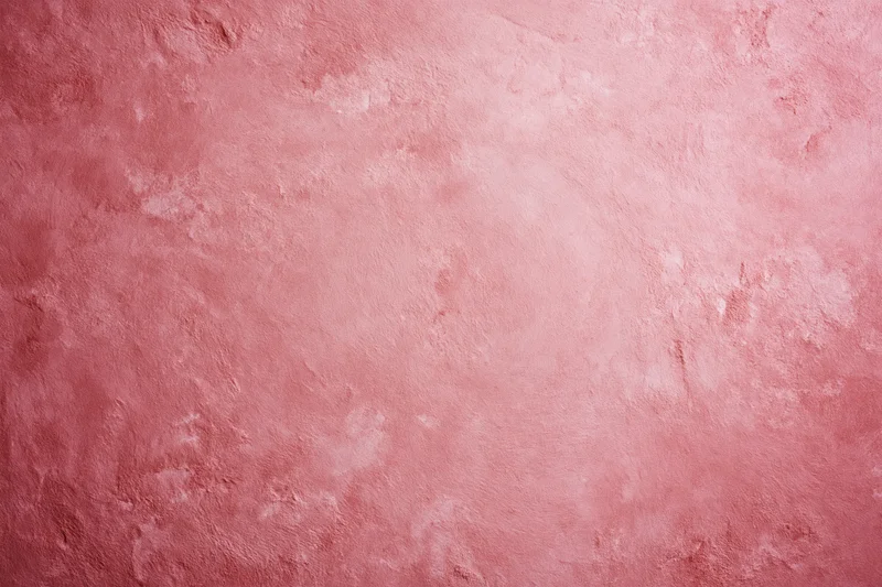 Matte pink textured surface filling the frame as a background
