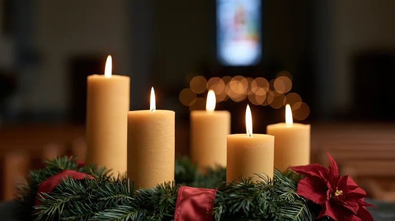 Four advent candles burning on an evergreen wreath in a church interior