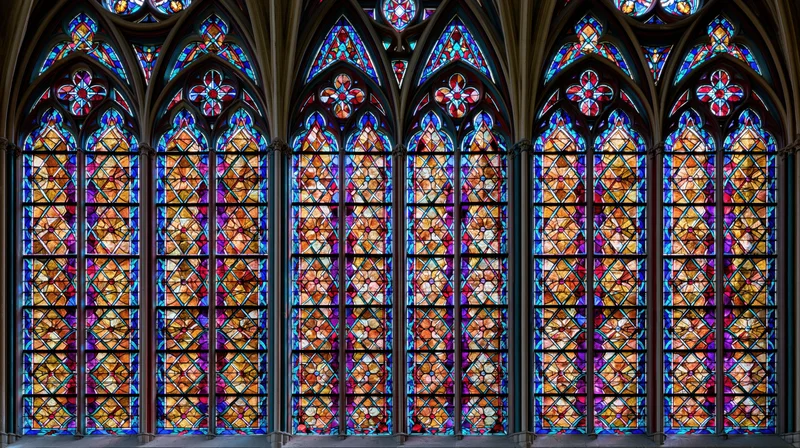 Gothic cathedral stained glass windows filling the interior with colorful light