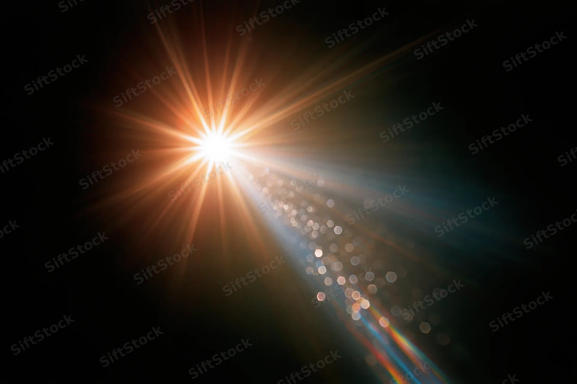 Intense lens flare burst from a single bright point light source in dark space with bokeh and light rays extending diagonally
