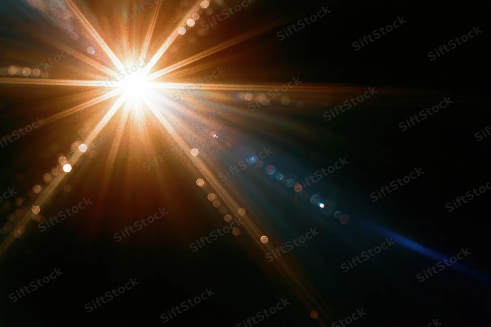Intense lens flare burst from a single bright point light source in dark space with radiating beams and bokeh circles