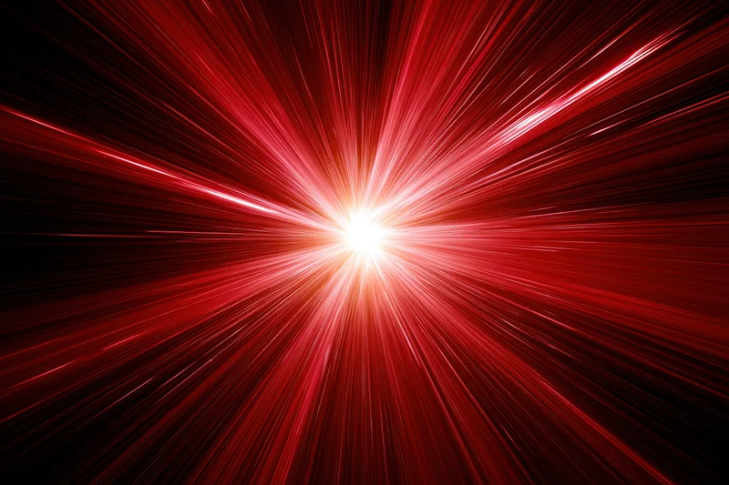 Intense radial light burst emanating from a central bright point in a dark red field