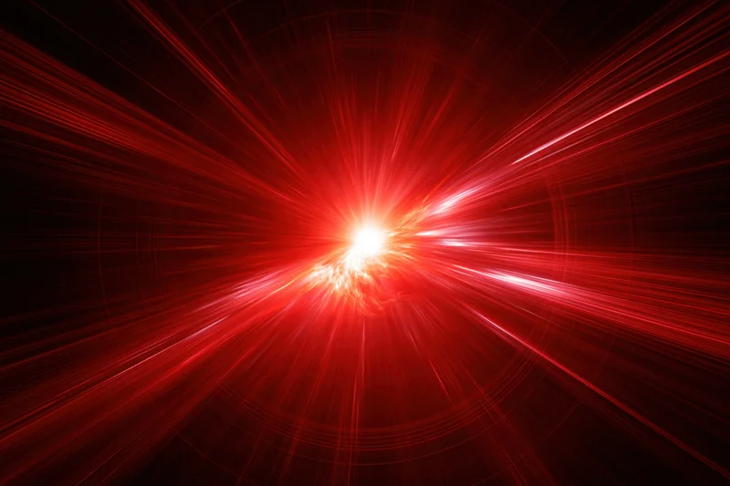 Intense red light burst radiating outward from a bright center