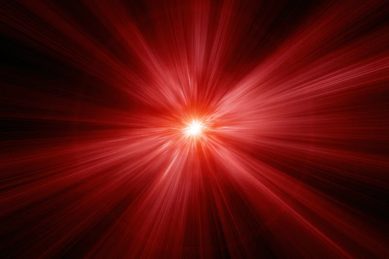 Intense red light burst radiating outward from a bright center