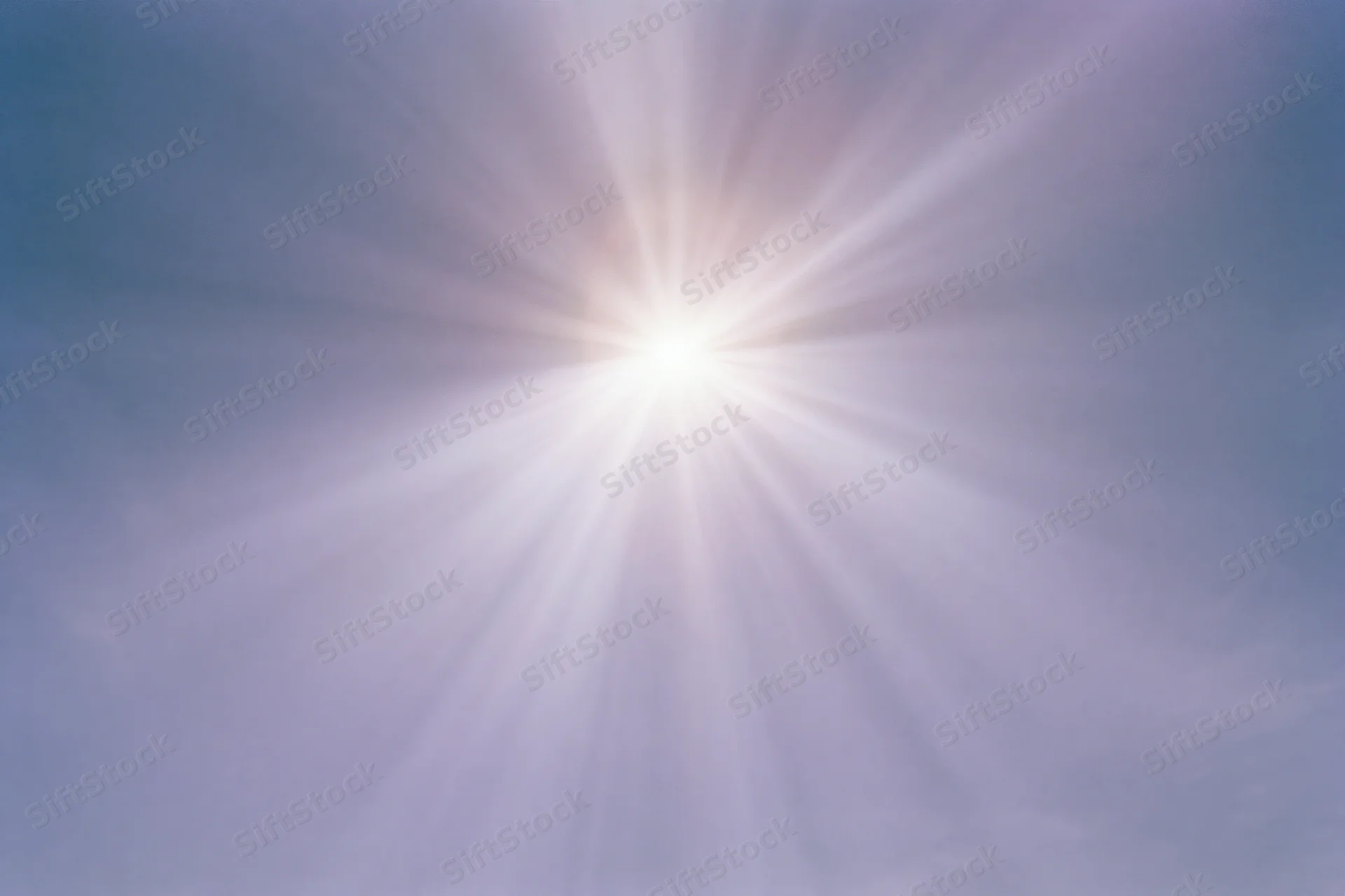 Intense sun flare bursting from upper center of frame against hazy sky