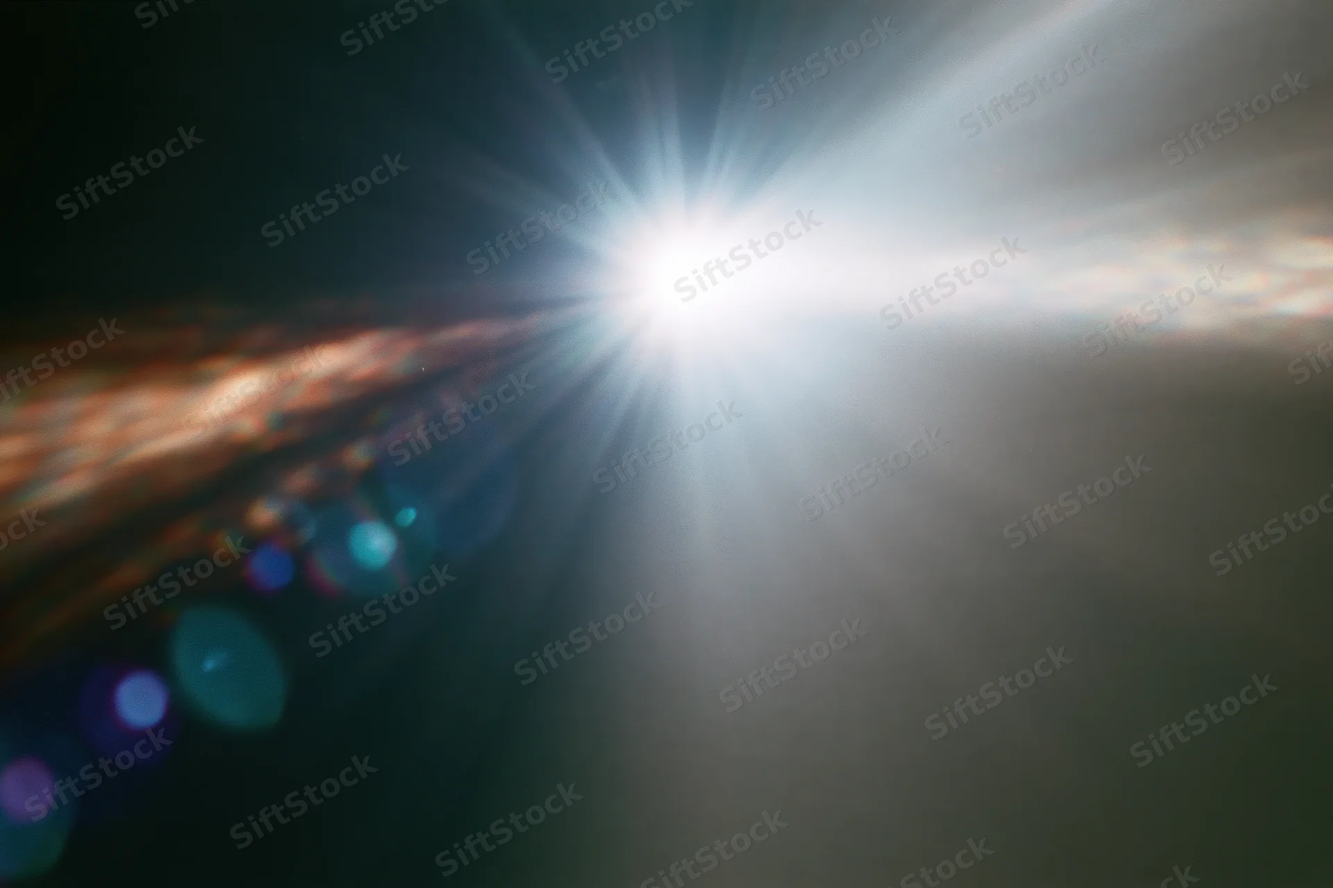 Intense white light source blazing against a near-black background with lens flare and bokeh effects