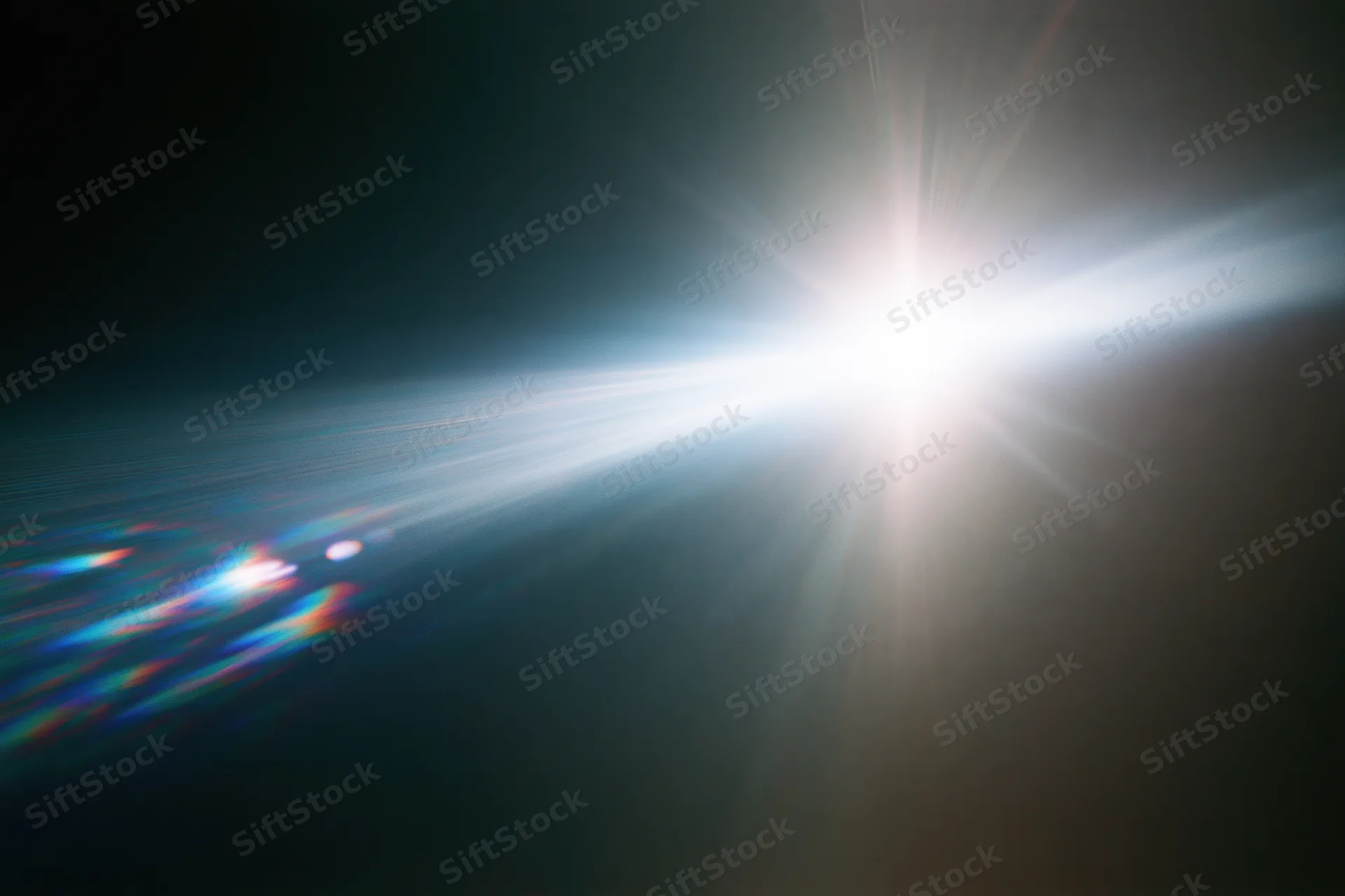 Intense white light source blazing against a near-black background with lens flare and colorful light streaks