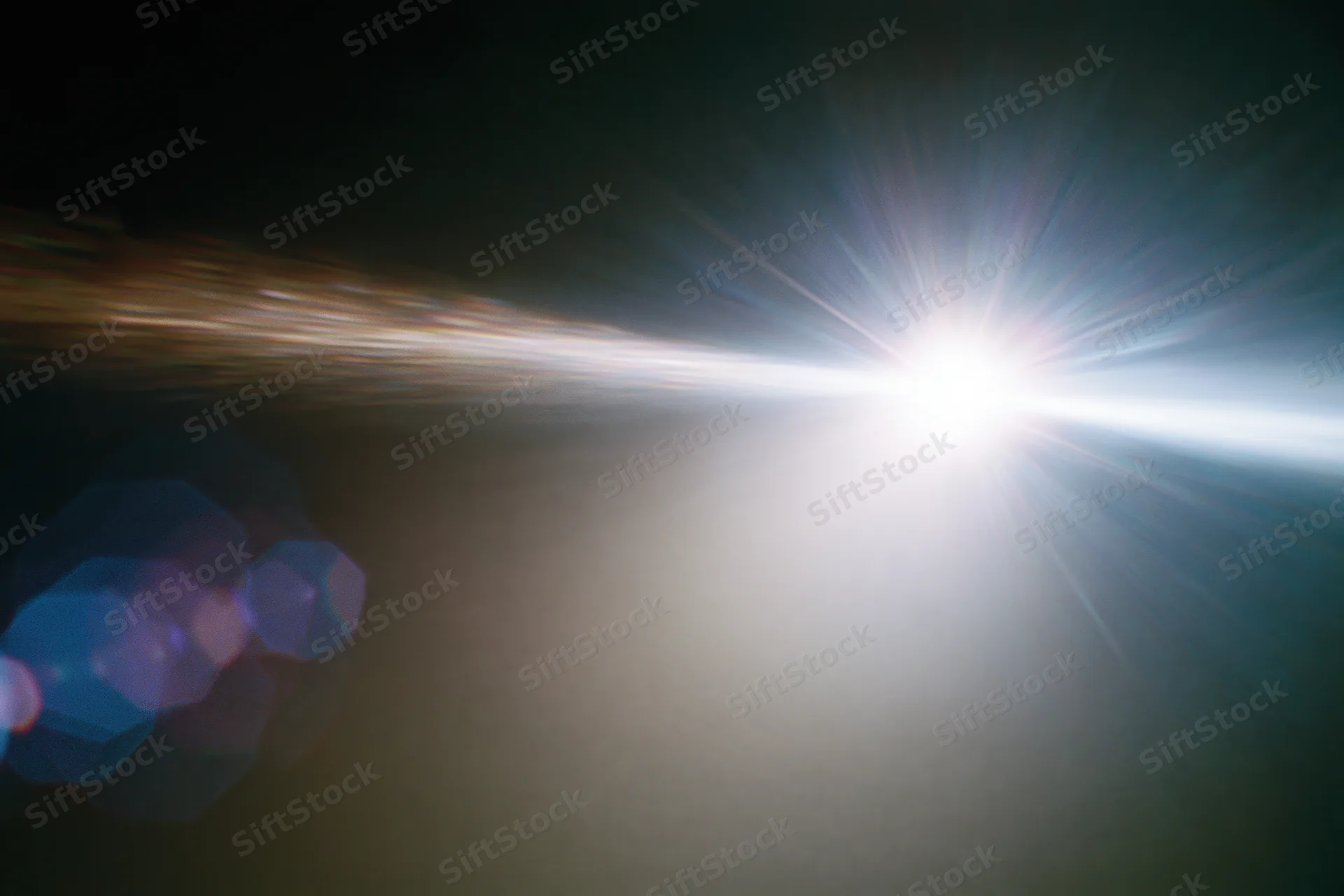 Intense white light source blazing against a near-black background with lens flare and bokeh effects