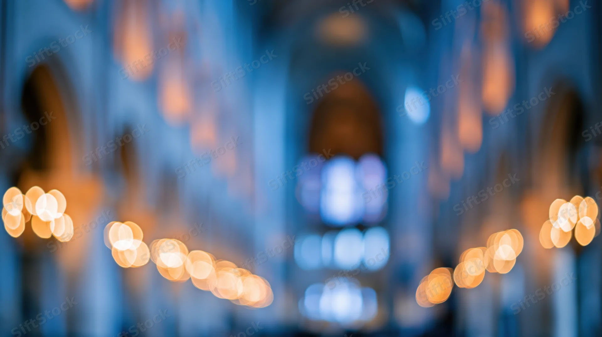 Blurred interior of a cathedral nave with warm bokeh lights and arched stone columns